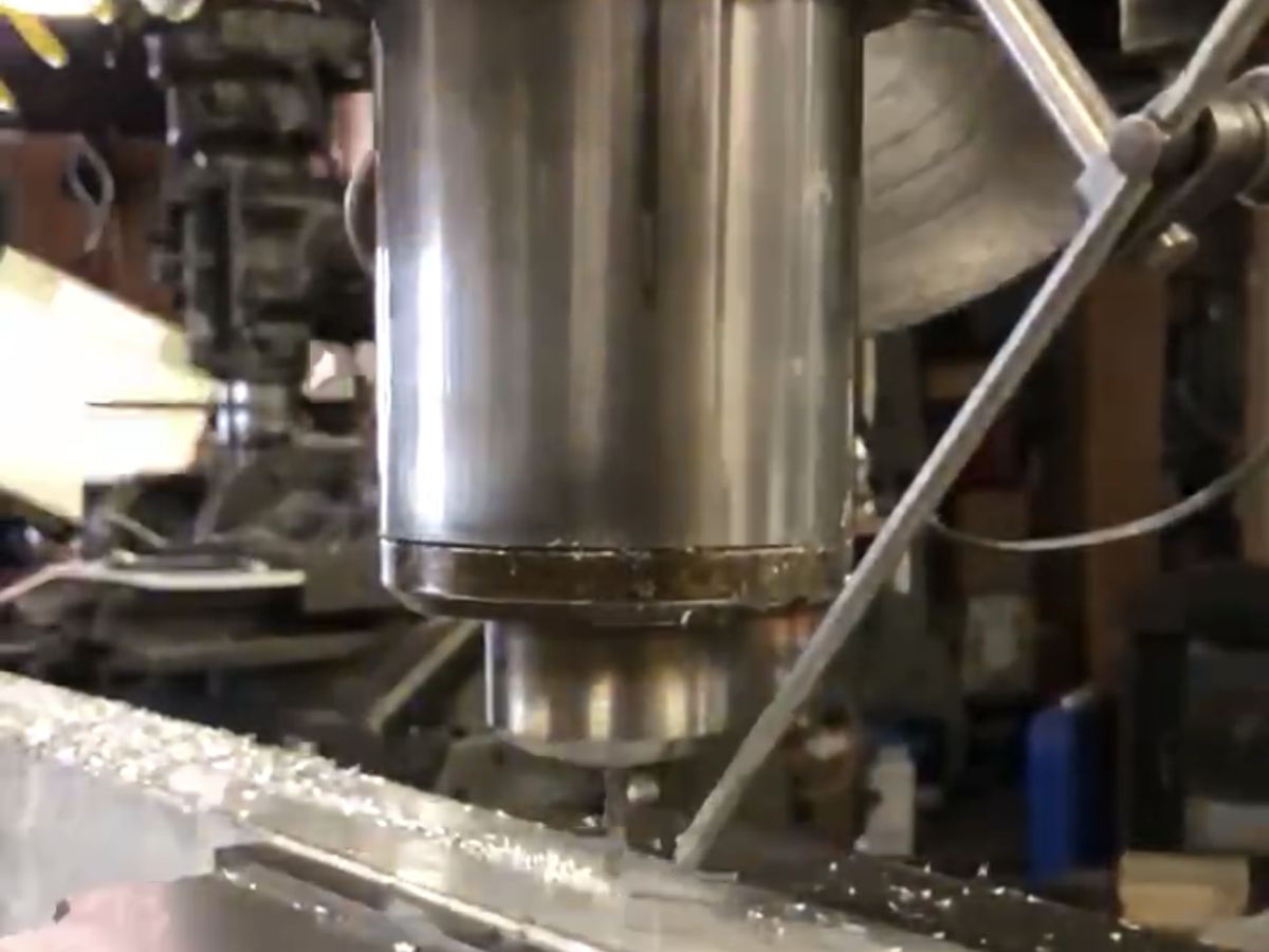 End mill cutting a slot in a long steel bar on the vertical mill at Crawford Machine